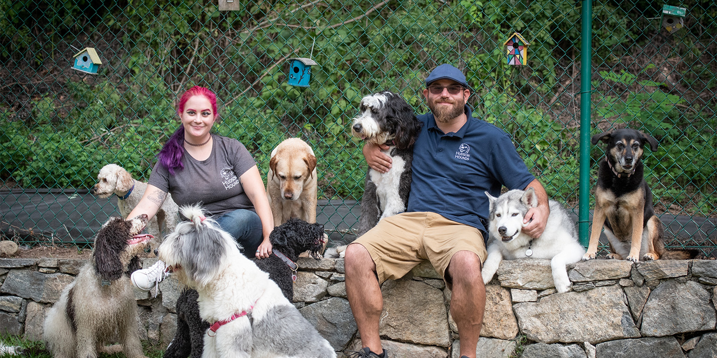 Noelle and Aaron team members seated with the pups
